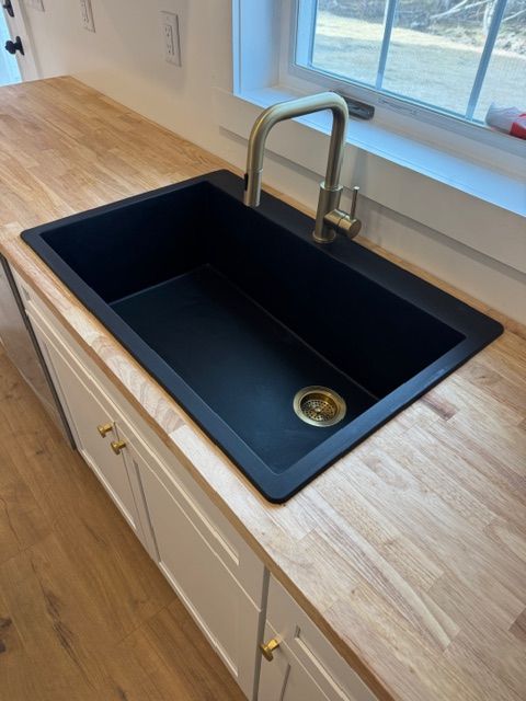 Kitchen remodel with black sink and butcher block countertop in Maine